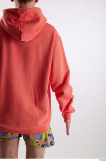 Nigel 1 arm back view dressed flexing salmon hoodie sweatshirt…